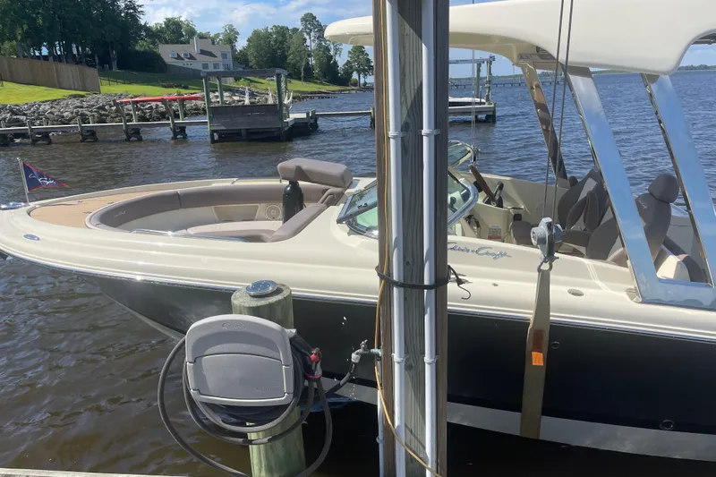  Yacht Photos Pics 2019 Chris-Craft Calypso 26 boat docked by a lakeside pier.