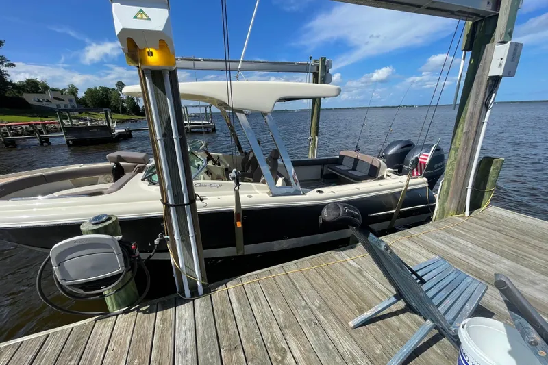  Yacht Photos Pics 2019 Chris-Craft Calypso 26 boat docked on a sunny day by the water.