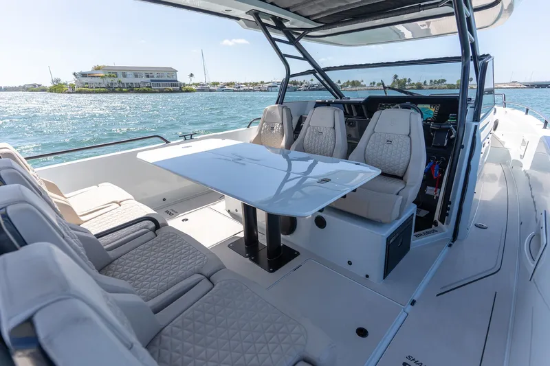 Kraken Yacht Photos Pics Interior of 2023 Axopar SHADOW 900ST with luxurious seating and table.