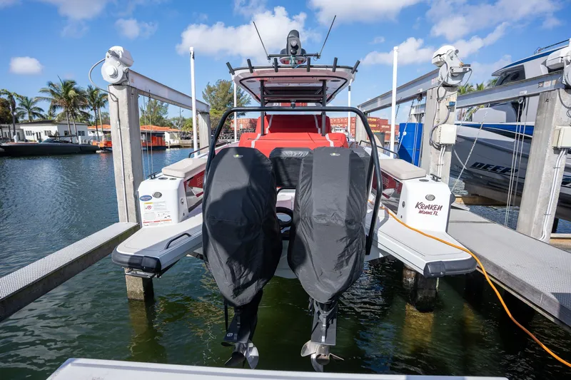 Kraken Yacht Photos Pics Axopar SHADOW 900ST 2023 on a boat lift at the marina.