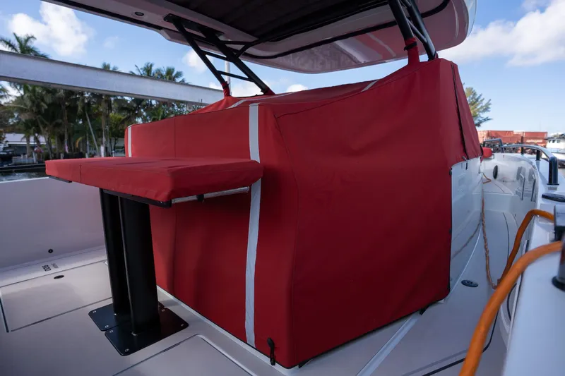 Kraken Yacht Photos Pics Axopar SHADOW 900ST 2023 with red cover and outdoor table.