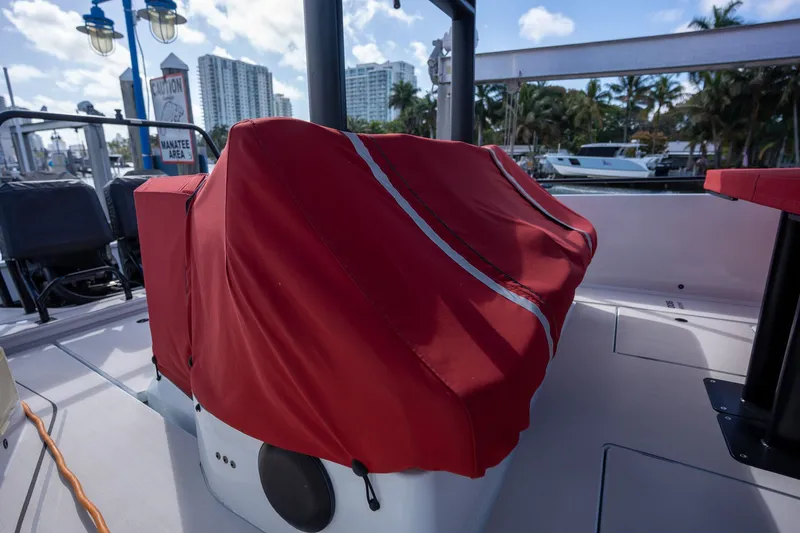 Kraken Yacht Photos Pics Axopar SHADOW 900ST 2023 with red cover at the marina.