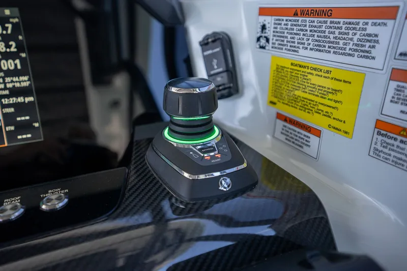 Kraken Yacht Photos Pics Axopar SHADOW 900ST 2023 control console with joystick and warning labels.