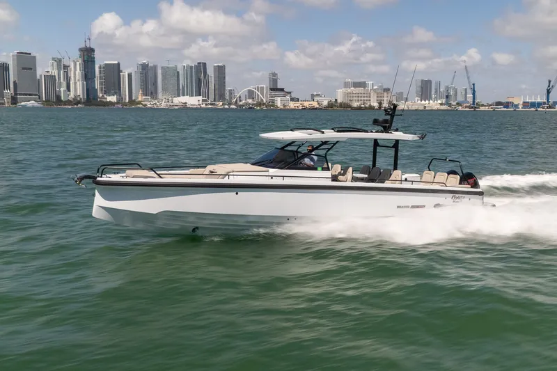 Kraken Yacht Photos Pics Axopar SHADOW 900ST 2023 cruising on water with city skyline.