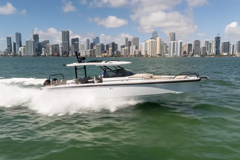 Kraken Yacht Photos Pics Axopar SHADOW 900ST 2023 cruising in front of city skyline.