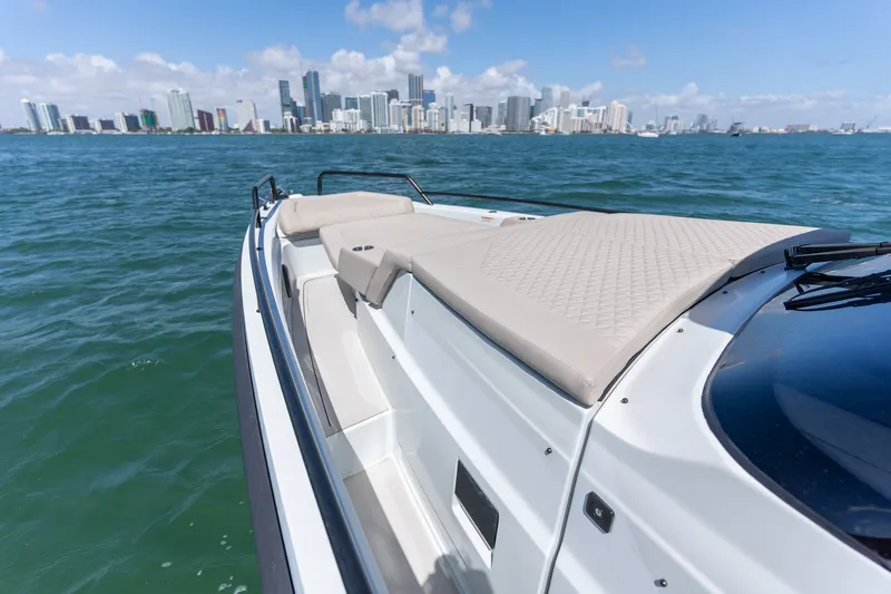Kraken Yacht Photos Pics Axopar SHADOW 900ST 2023 on water with city skyline view.