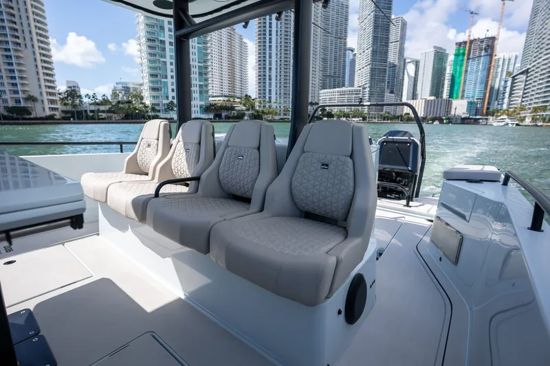 Kraken Yacht Photos Pics Interior of 2023 Axopar SHADOW 900ST with luxury seating and cityscape view.