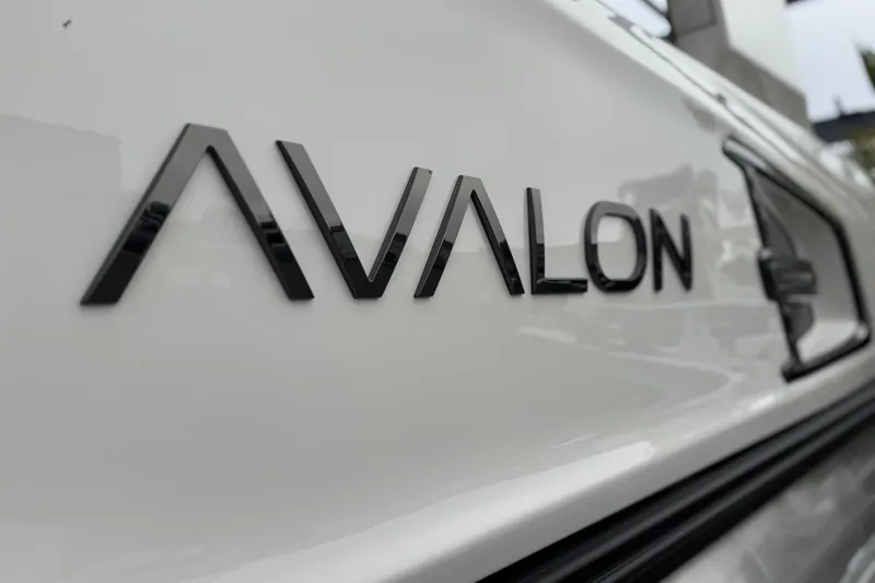  Yacht Photos Pics Close-up of 2026 Avalon Excalibur 27' logo on white surface.