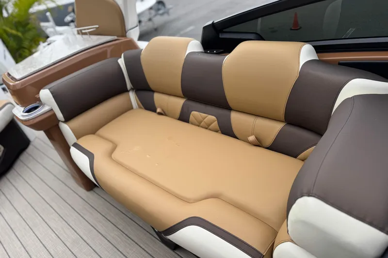  Yacht Photos Pics Luxurious seating on 2026 Avalon Excalibur 27' boat, featuring tan and brown upholstery.