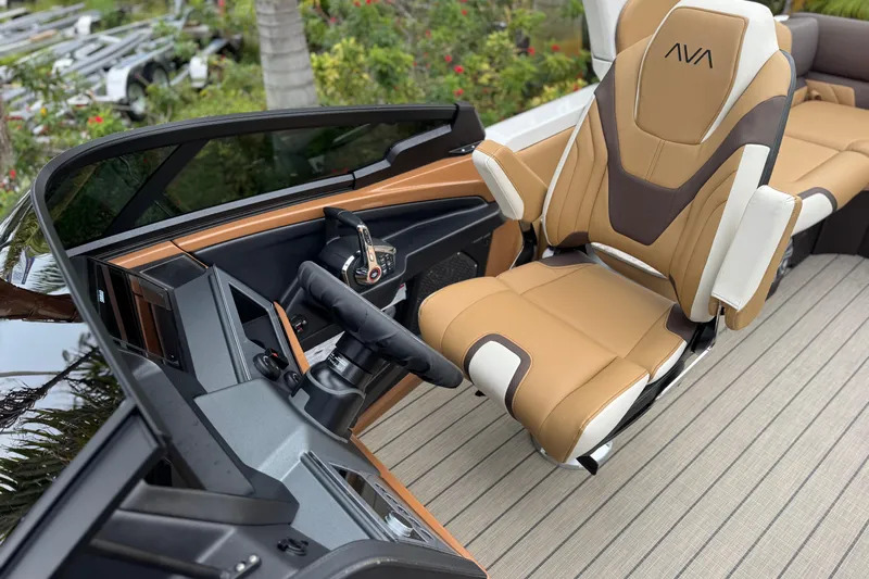  Yacht Photos Pics 2026 Avalon Excalibur 27' boat interior with luxurious captain's chair and modern dashboard.