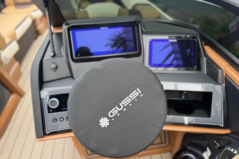  Yacht Photos Pics Steering wheel and dashboard of 2026 Avalon Excalibur 27' boat with Gussi Italia branding.