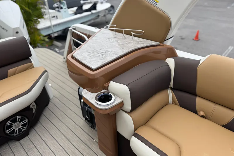  Yacht Photos Pics Luxurious seating and table on 2026 Avalon Excalibur 27' boat, featuring elegant design and comfort.