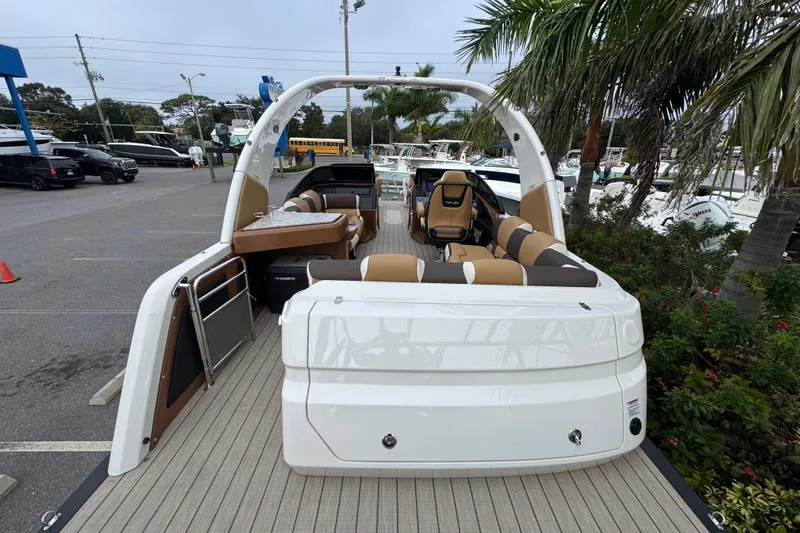  Yacht Photos Pics 2026 Avalon Excalibur 27' boat with luxurious seating and modern design in a marina setting.