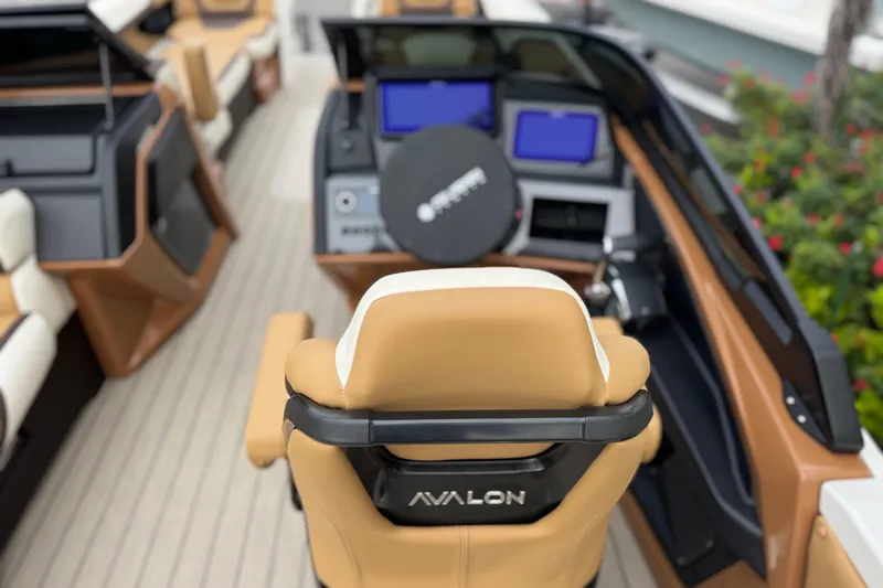 Yacht Photos Pics 2026 Avalon Excalibur 27' boat interior with tan seating and modern dashboard.