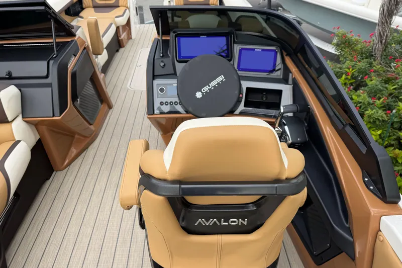 Yacht Photos Pics Luxurious interior of 2026 Avalon Excalibur 27' boat with modern dashboard and seating.