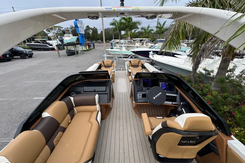  Yacht Photos Pics Luxurious 2026 Avalon Excalibur 27' boat with elegant seating and modern dashboard.