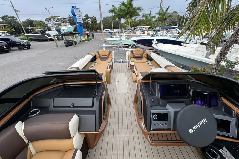  Yacht Photos Pics 2026 Avalon Excalibur 27' luxury boat interior with modern dashboard and seating at a marina.