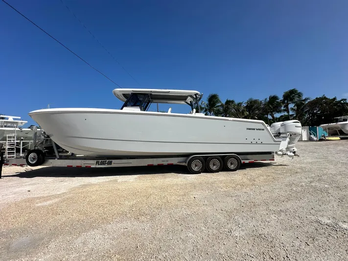  Yacht Photos Pics 2026 Twin Vee 400 GFX2 CC boat on trailer under clear blue sky.