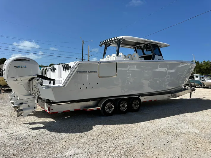  Yacht Photos Pics 2026 Twin Vee 400 GFX2 CC boat on trailer, featuring Yamaha engines, under clear blue sky.