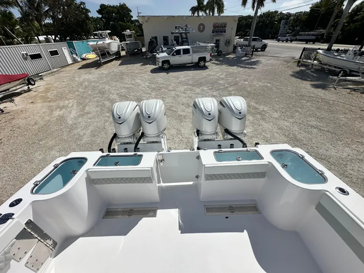  Yacht Photos Pics 2026 Twin Vee 400 GFX2 CC boat with four powerful outboard engines in a dealership lot.