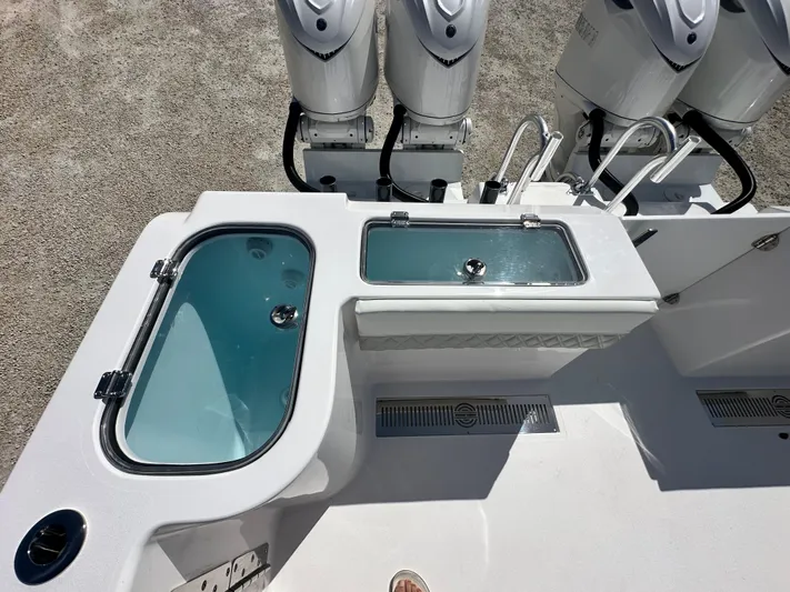  Yacht Photos Pics 2026 Twin Vee 400 GFX2 CC boat deck with live wells and triple outboard motors.