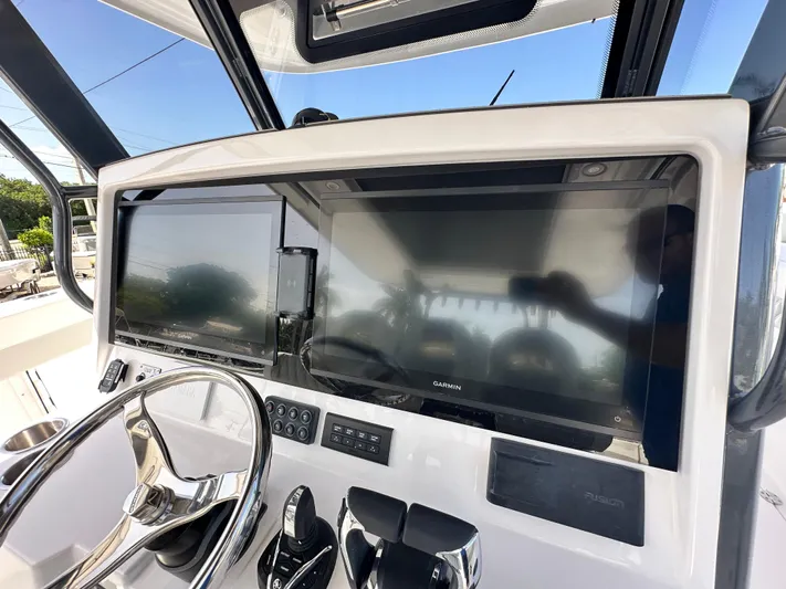  Yacht Photos Pics 2026 Twin Vee 400 GFX2 CC boat dashboard with dual Garmin displays and steering wheel.