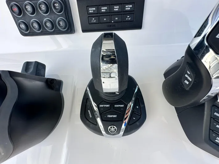  Yacht Photos Pics Control panel of 2026 Twin Vee 400 GFX2 CC boat with joystick and buttons.