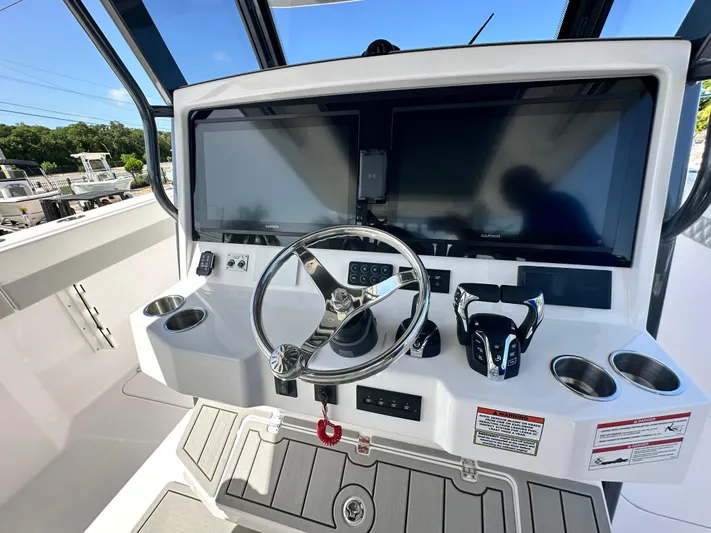  Yacht Photos Pics 2026 Twin Vee 400 GFX2 CC boat dashboard with dual screens and steering wheel.