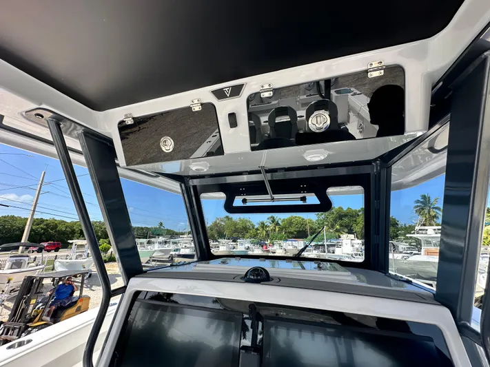  Yacht Photos Pics 2026 Twin Vee 400 GFX2 CC boat interior with modern dashboard and overhead storage.