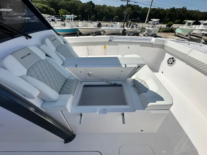  Yacht Photos Pics 2026 Twin Vee 400 GFX2 CC boat interior with open storage compartment and cushioned seating.