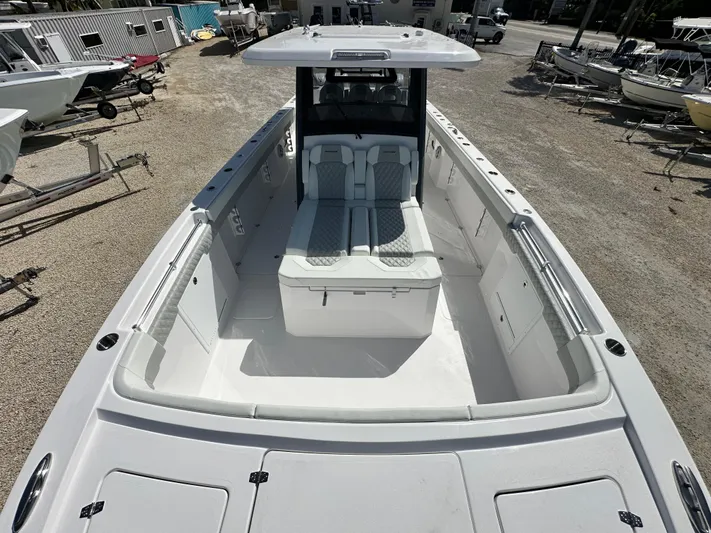  Yacht Photos Pics 2026 Twin Vee 400 GFX2 CC boat, spacious deck, modern design, parked in a marina.