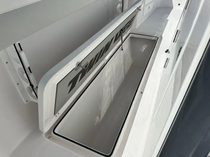  Yacht Photos Pics 2026 Twin Vee 400 GFX2 CC boat storage compartment, open lid, white interior.