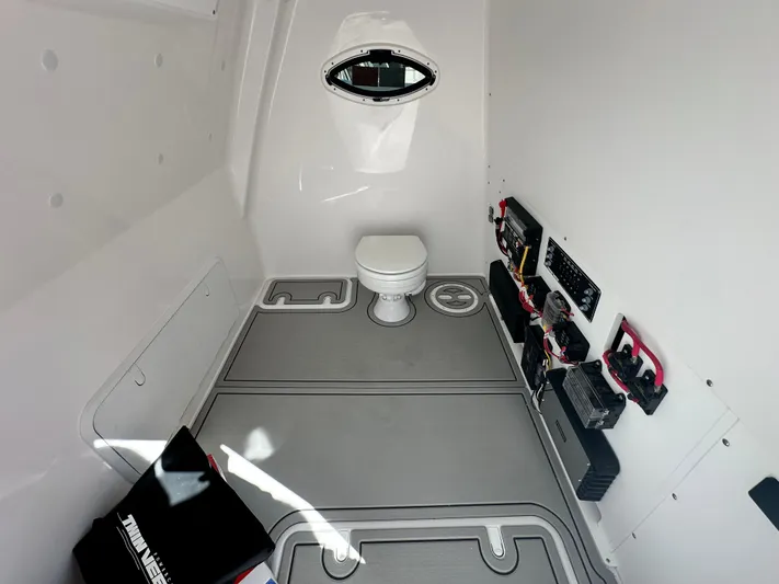  Yacht Photos Pics Interior of 2026 Twin Vee 400 GFX2 CC boat, featuring a compact marine toilet.