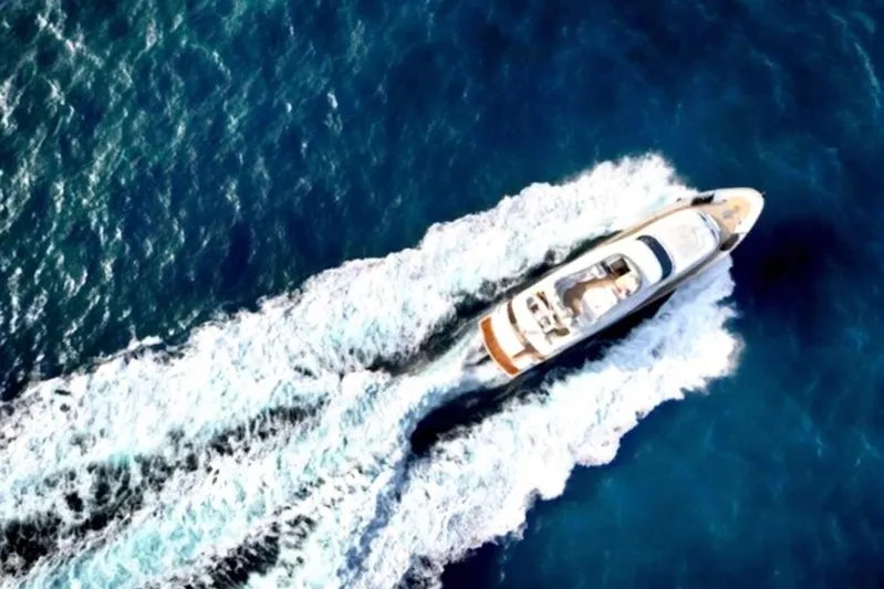  Yacht Photos Pics Aerial view of 1998 Maiora MAIORA 29 DP yacht cruising on blue ocean waters.