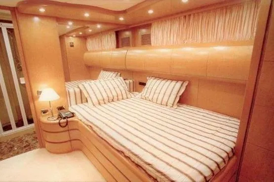  Yacht Photos Pics Luxurious bedroom interior of 1998 Maiora MAIORA 29 DP yacht with striped bedding.