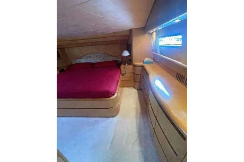  Yacht Photos Pics Luxurious bedroom interior of 1998 Maiora MAIORA 29 DP yacht with elegant wood finish.