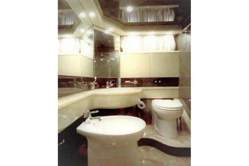  Yacht Photos Pics Luxurious bathroom interior of 1998 Maiora MAIORA 29 DP yacht, featuring elegant fixtures and lighting.