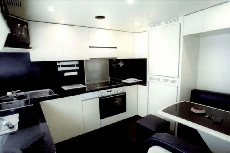  Yacht Photos Pics Luxurious kitchen interior of 1998 Maiora MAIORA 29 DP yacht, featuring modern appliances.