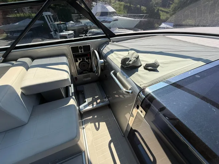  Yacht Photos Pics Interior of a 2019 VanDutch 55 yacht, featuring sleek seating and modern controls.