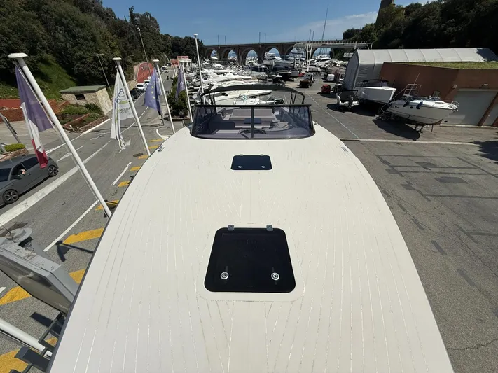  Yacht Photos Pics VanDutch 55 yacht, 2019 model, docked in a marina with surrounding boats and flags.