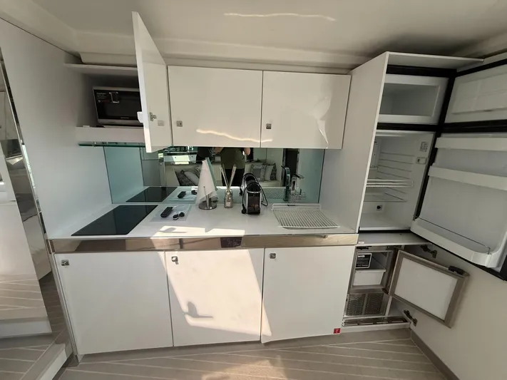  Yacht Photos Pics Modern kitchen interior of 2019 VanDutch 55 yacht with sleek white cabinetry and appliances.