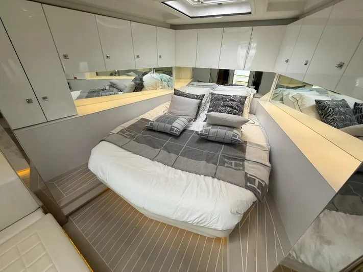  Yacht Photos Pics Luxurious bedroom interior of 2019 VanDutch 55 yacht with modern design and mirrored cabinets.