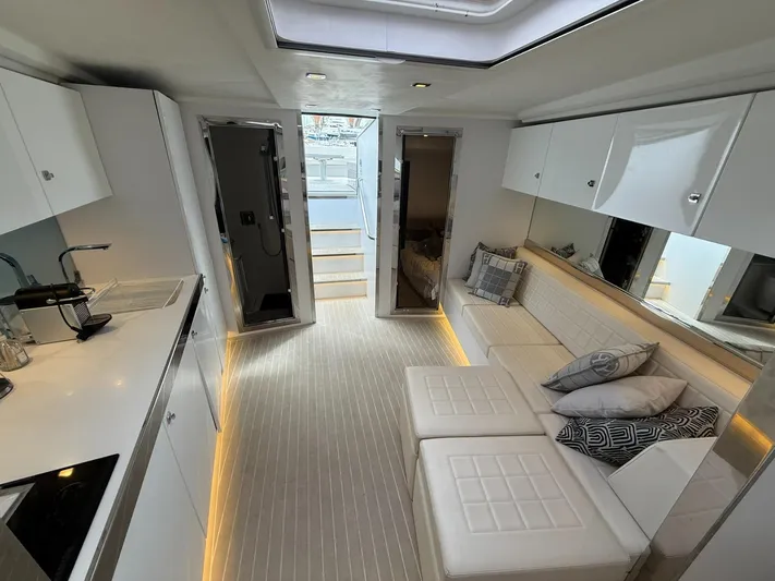  Yacht Photos Pics Luxurious interior of 2019 VanDutch 55 yacht with modern white furnishings and ambient lighting.