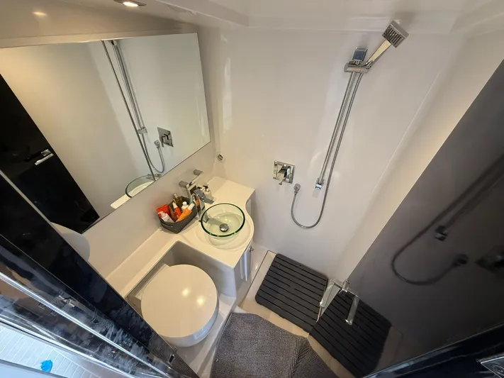  Yacht Photos Pics Luxurious bathroom in 2019 VanDutch 55 yacht with modern fixtures and sleek design.