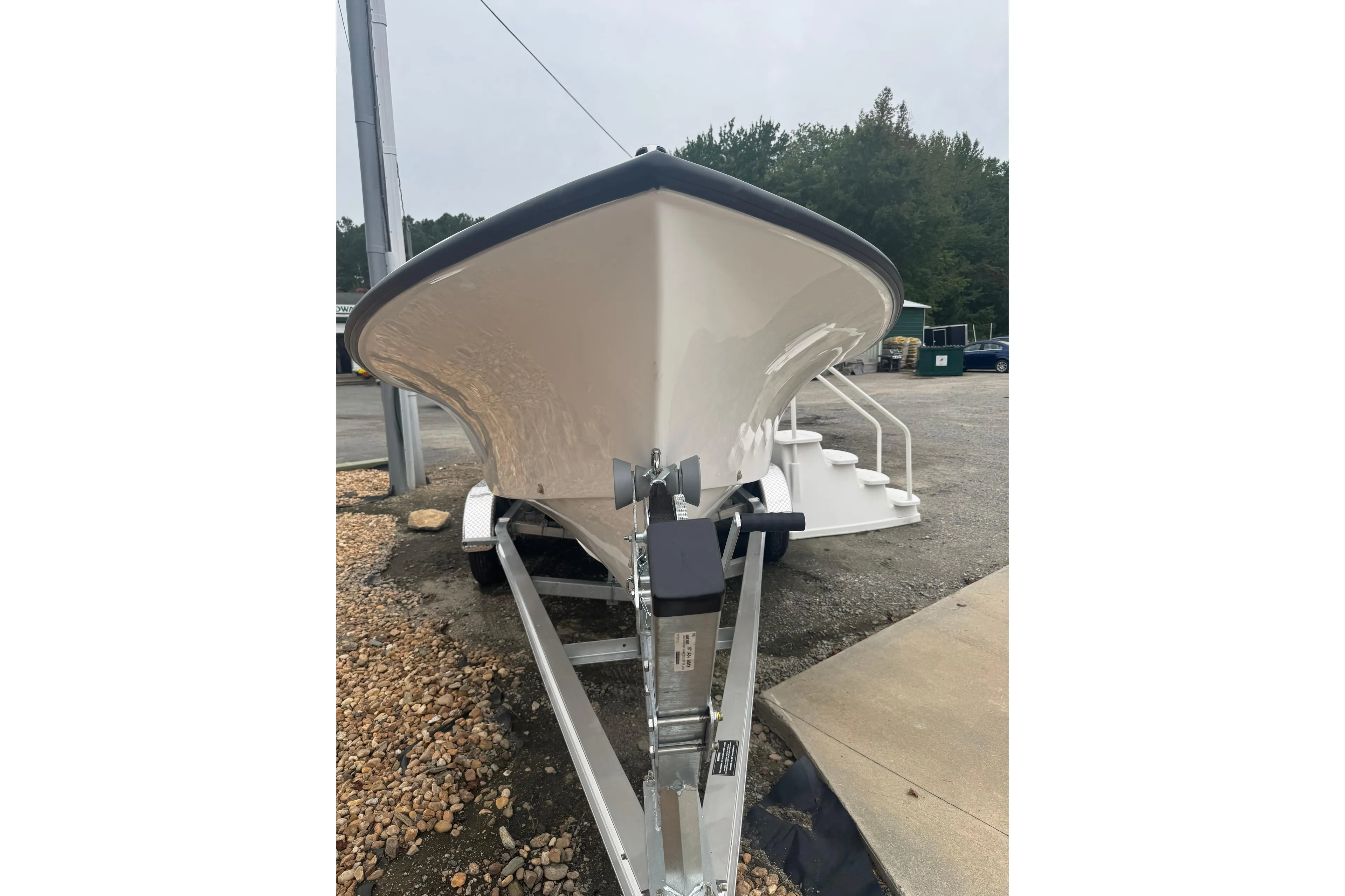 2026 C-Hawk 23 Center Console boat on trailer, front view, outdoors.