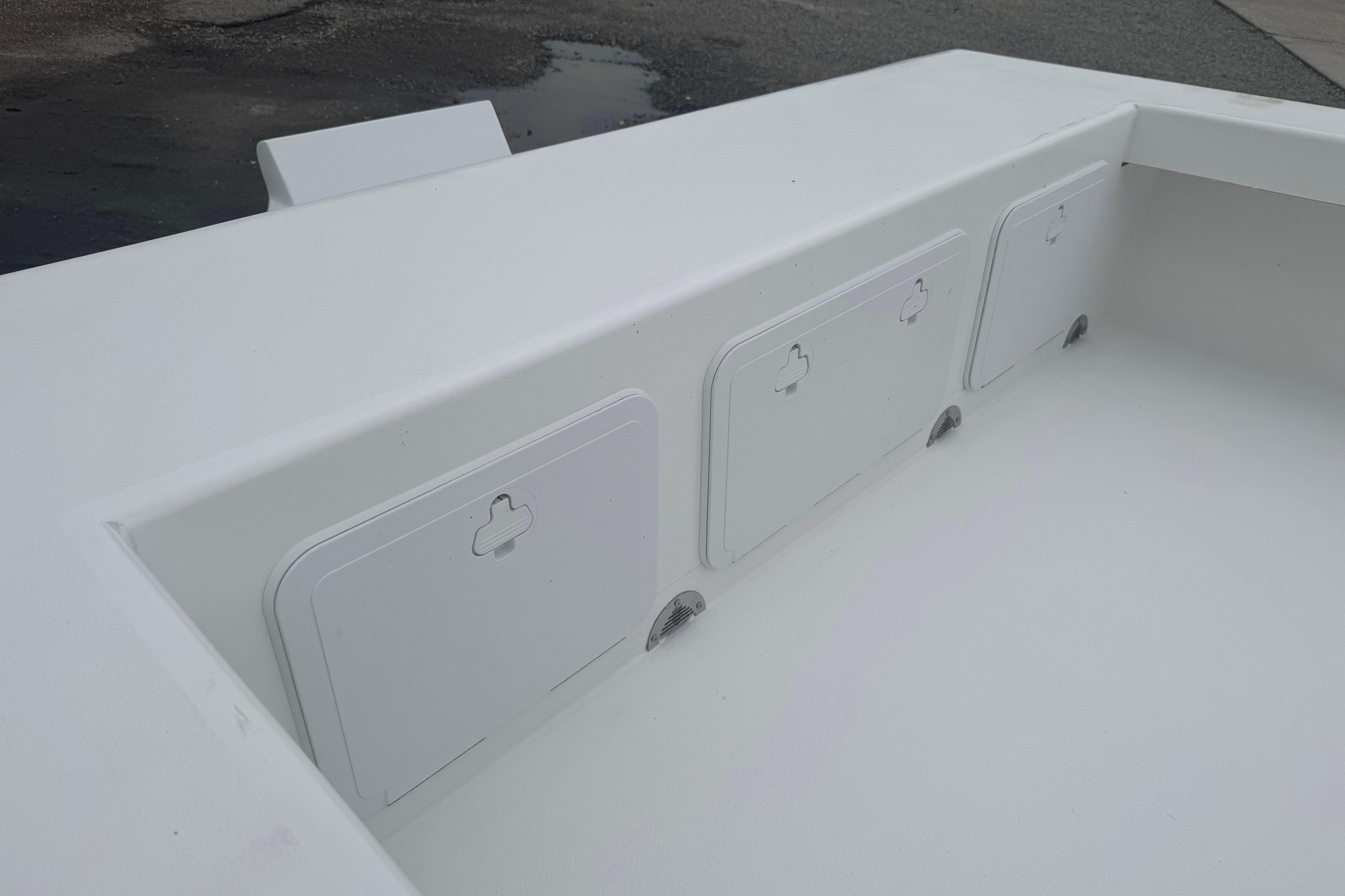 2026 C-Hawk 23 Center Console boat storage compartments, white finish, outdoor setting.