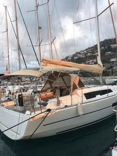  Yacht Photos Pics 2015 Dufour 382 Grand Large sailboat docked in marina, with scenic hillside backdrop.