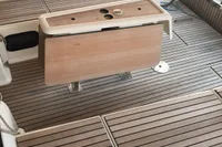 2015 Dufour 382 Grand Large yacht cockpit with teak flooring and foldable table.