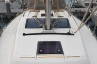 2015 Dufour 382 Grand Large sailboat docked at marina, showcasing deck and mast.