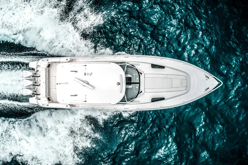  Yacht Photos Pics Manufacturer Provided Image: Aerial view of 2023 Intrepid 438 Evolution yacht cruising on blue ocean water.